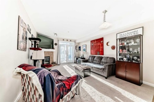 206-1005B Westmount Drive, Strathmore, AB - Indoor Photo Showing Living Room With Fireplace