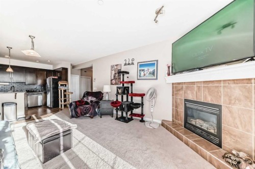 206-1005B Westmount Drive, Strathmore, AB - Indoor Photo Showing Living Room With Fireplace