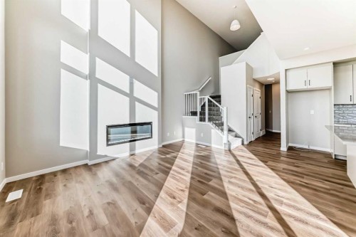 1089 Sawgrass Link Nw, Airdrie, AB - Indoor Photo Showing Other Room With Fireplace