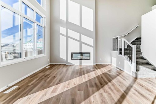 1089 Sawgrass Link Nw, Airdrie, AB - Indoor Photo Showing Other Room With Fireplace