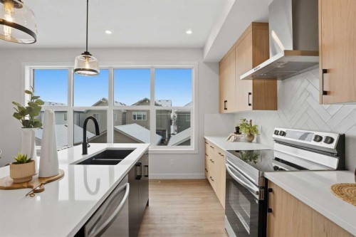 77 Wild Rose Way Se, Calgary, AB - Indoor Photo Showing Kitchen With Stainless Steel Kitchen With Double Sink With Upgraded Kitchen