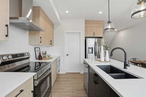 77 Wild Rose Way Se, Calgary, AB - Indoor Photo Showing Kitchen With Stainless Steel Kitchen With Double Sink With Upgraded Kitchen