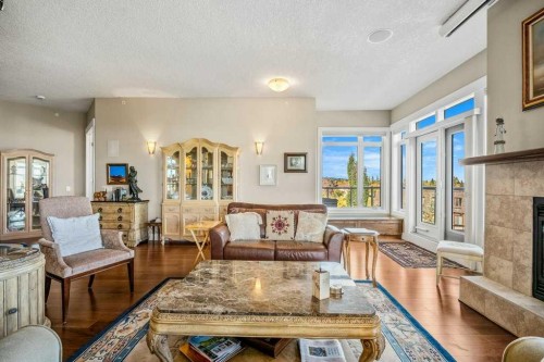 404-4 Hemlock Crescent Sw, Calgary, AB - Indoor Photo Showing Living Room With Fireplace