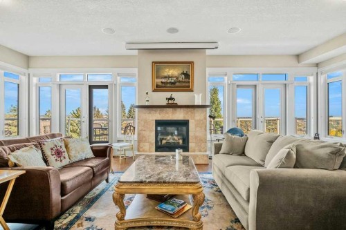 404-4 Hemlock Crescent Sw, Calgary, AB - Indoor Photo Showing Living Room With Fireplace