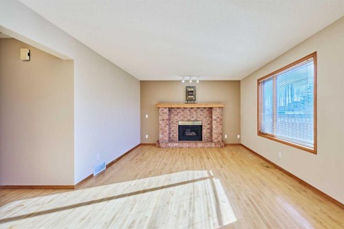 177 Harvest Hills Drive Ne, Calgary, AB - Indoor Photo Showing Living Room With Fireplace
