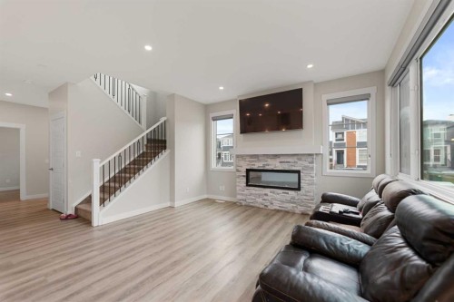 7 Corner Glen Common Ne, Calgary, AB - Indoor Photo Showing Living Room With Fireplace