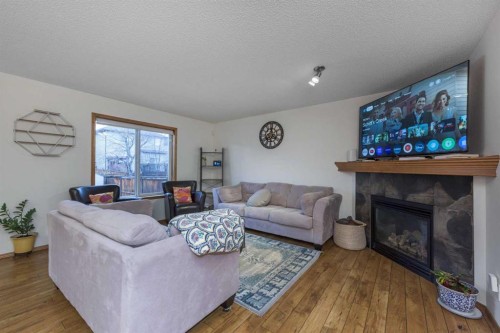74 Tuscany Springs Hill Nw, Calgary, AB - Indoor Photo Showing Living Room With Fireplace