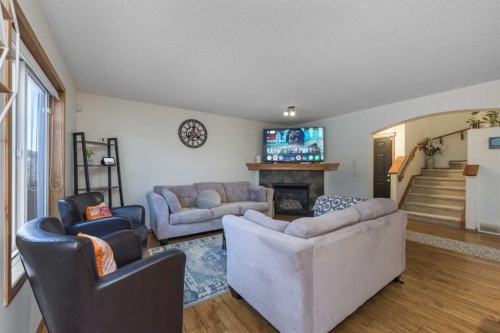 74 Tuscany Springs Hill Nw, Calgary, AB - Indoor Photo Showing Living Room With Fireplace
