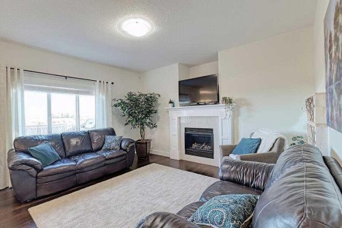 1708 Monteith Drive Se, High River, AB - Indoor Photo Showing Living Room With Fireplace