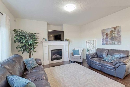 1708 Monteith Drive Se, High River, AB - Indoor Photo Showing Living Room With Fireplace