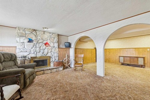 11427 Wilkes Road Se, Calgary, AB - Indoor Photo Showing Living Room With Fireplace