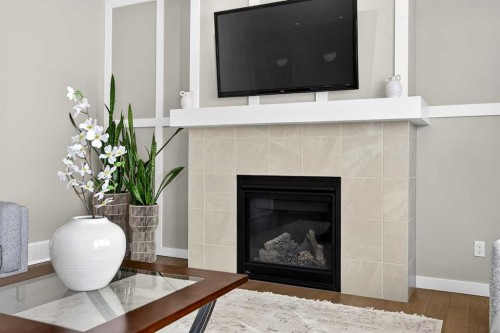 144 Sundown View, Cochrane, AB - Indoor Photo Showing Living Room With Fireplace
