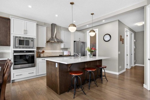 144 Sundown View, Cochrane, AB - Indoor Photo Showing Kitchen With Stainless Steel Kitchen With Upgraded Kitchen