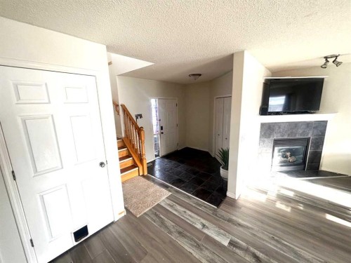 531 Stonegate Road Nw, Airdrie, AB - Indoor Photo Showing Other Room With Fireplace