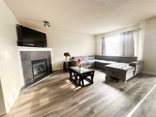 531 Stonegate Road Nw, Airdrie, AB - Indoor Photo Showing Living Room With Fireplace