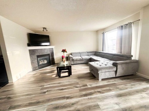 531 Stonegate Road Nw, Airdrie, AB - Indoor Photo Showing Living Room With Fireplace