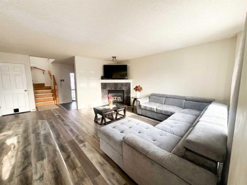 531 Stonegate Road Nw, Airdrie, AB - Indoor Photo Showing Living Room With Fireplace