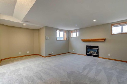 208 Railway Avenue, Cheadle, AB - Indoor Photo Showing Other Room With Fireplace