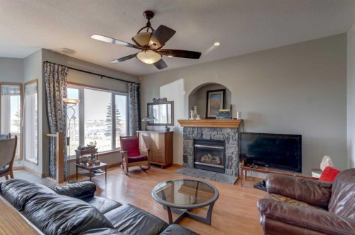 208 Railway Avenue, Cheadle, AB - Indoor Photo Showing Living Room With Fireplace