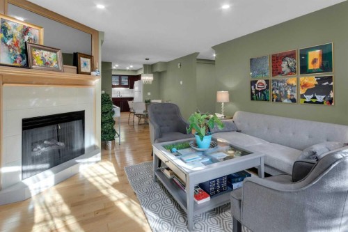3-124 19 Avenue Ne, Calgary, AB - Indoor Photo Showing Living Room With Fireplace