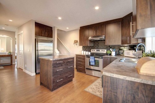 1606-2445 Kingsland Road Se, Airdrie, AB - Indoor Photo Showing Kitchen With Double Sink