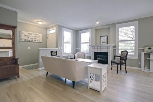 92 Prestwick Gardens Se, Calgary, AB - Indoor Photo Showing Living Room With Fireplace