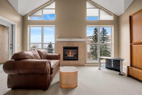 702 Patterson View Sw, Calgary, AB - Indoor Photo Showing Living Room With Fireplace