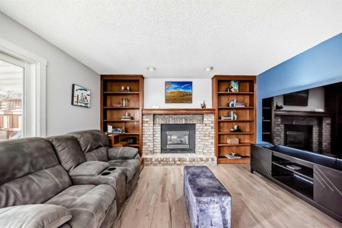 7 Sunset Crescent, Okotoks, AB - Indoor Photo Showing Living Room With Fireplace
