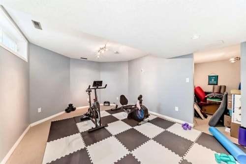 7 Sunset Crescent, Okotoks, AB - Indoor Photo Showing Gym Room