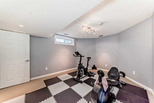 7 Sunset Crescent, Okotoks, AB - Indoor Photo Showing Gym Room