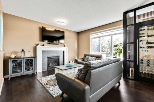 205 Aspenmere Way, Chestermere, AB - Indoor Photo Showing Living Room With Fireplace