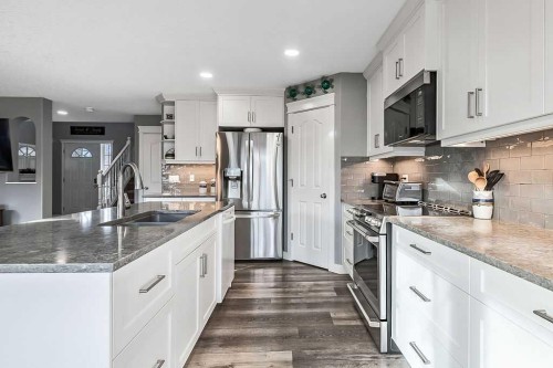 115 Cougarstone Square Sw, Calgary, AB - Indoor Photo Showing Kitchen With Double Sink With Upgraded Kitchen