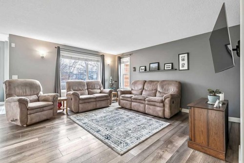 115 Cougarstone Square Sw, Calgary, AB - Indoor Photo Showing Living Room