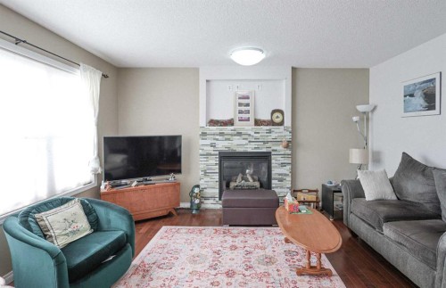 125 Silverado Range Cove Sw, Calgary, AB - Indoor Photo Showing Living Room With Fireplace