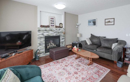 125 Silverado Range Cove Sw, Calgary, AB - Indoor Photo Showing Living Room With Fireplace