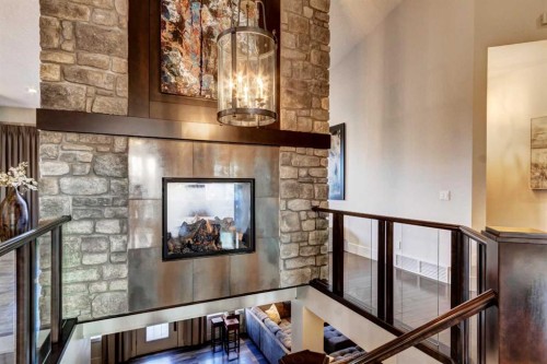 566 Pine Creek Ridge, Heritage Pointe, AB - Indoor Photo Showing Other Room With Fireplace