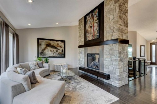 566 Pine Creek Ridge, Heritage Pointe, AB - Indoor Photo Showing Living Room With Fireplace