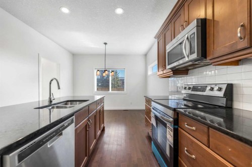 1006 Shantz Place, Crossfield, AB - Indoor Photo Showing Kitchen With Double Sink With Upgraded Kitchen