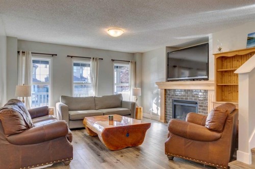 199 Everglen Way Sw, Calgary, AB - Indoor Photo Showing Living Room With Fireplace