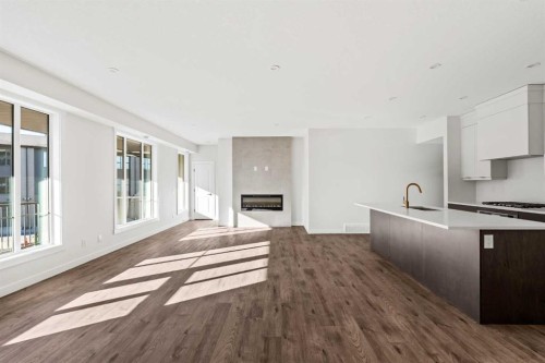 609 Sovereign Common Sw, Calgary, AB - Indoor Photo Showing Kitchen With Fireplace