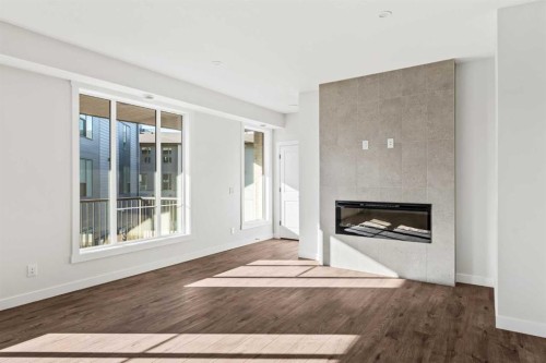 609 Sovereign Common Sw, Calgary, AB - Indoor Photo Showing Living Room With Fireplace