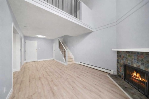 104-1817 14A Street Sw, Calgary, AB - Indoor Photo Showing Other Room With Fireplace