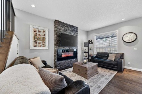 143 Cranarch Crescent Se, Calgary, AB - Indoor Photo Showing Living Room With Fireplace