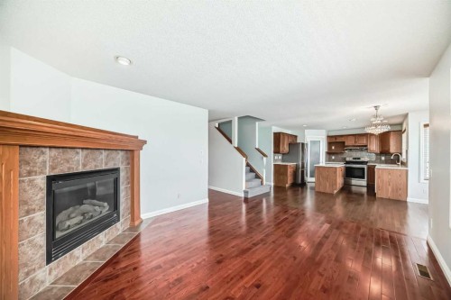 234 Panatella Boulevard Nw, Calgary, AB - Indoor Photo Showing Living Room With Fireplace