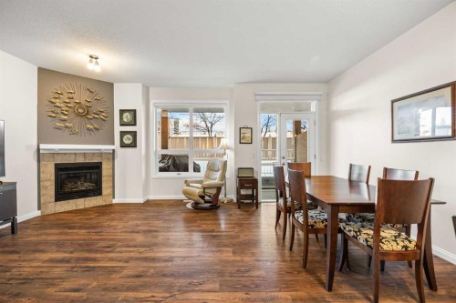 156 Royal Manor Nw, Calgary, AB - Indoor Photo Showing Dining Room With Fireplace