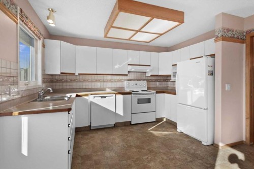 222 Arbour Cliff Close Nw, Calgary, AB - Indoor Photo Showing Kitchen With Double Sink