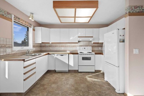 222 Arbour Cliff Close Nw, Calgary, AB - Indoor Photo Showing Kitchen With Double Sink