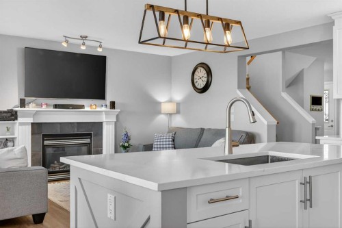 201 Saddlecrest Way Ne, Calgary, AB - Indoor Photo Showing Kitchen With Fireplace