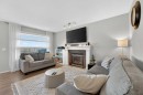 201 Saddlecrest Way Ne, Calgary, AB  - Indoor Photo Showing Living Room With Fireplace 