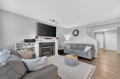 201 Saddlecrest Way Ne, Calgary, AB - Indoor Photo Showing Living Room With Fireplace